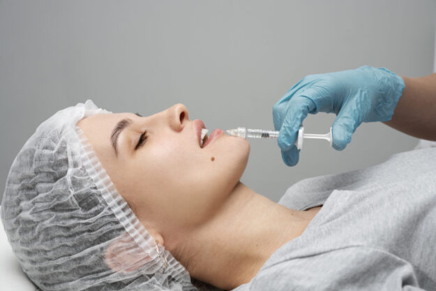 side-view-woman-getting-injection (1) Patient Receiving Hyaluronic Acid Facial Injection